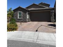 Charming single-Gathering home with stone accents, a paved driveway and well manicured landscaping at 4376 Latitude Valley Ct, North Las Vegas, NV 89084