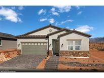 Charming single-story home featuring stone accents, a two-car garage, and a well-manicured front yard at 516 Hamilton Dr # Lot 25, Mesquite, NV 89027