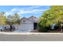 Charming single-story home with a well-maintained lawn and an attached two-car garage at 5512 Del Lago Dr, Las Vegas, NV 89130