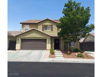 Charming two-story home featuring a neutral palette, well-kept lawn and convenient attached two-car garage at 5516 Coyote Falls Ct, Las Vegas, NV 89131