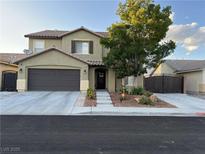Charming two-story home with a well-maintained yard and a two-car garage at 5516 Coyote Falls Ct, Las Vegas, NV 89131