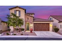 Charming two-story home with a brick-accented entrance and landscaped front yard at twilight at 5650 Pleasant Palms St, North Las Vegas, NV 89081