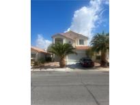 Two-story home with desert landscaping, garage, and a red tile roof on a sunny day at 7228 Chic Ave, Las Vegas, NV 89129