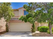 Charming two-story home featuring a two-car garage, lush landscaping, and a tiled roof in a desirable neighborhood at 7924 Horn Tail Ct, Las Vegas, NV 89131