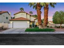 Charming two-story home with a well-manicured lawn and mature palm trees at 8388 Brad Oaks Cir, Las Vegas, NV 89123