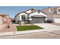 Charming single-story home featuring a manicured lawn and a two-car garage at 9604 Flying Eagle Ln, Las Vegas, NV 89123