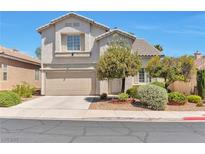 Charming two-story home featuring a tan stucco exterior, complemented by a well-manicured front yard at 9748 Derbyhill Cir, Las Vegas, NV 89117