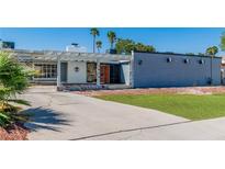 Charming single-story home featuring a covered entryway, stone accents, and a well-manicured lawn at 1679 Raindance Way, Las Vegas, NV 89169
