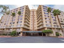 A bright, multi-story condo building with palm trees and a covered entry at 205 E Harmon Ave # 112, Las Vegas, NV 89169