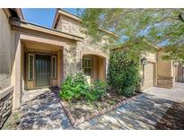 Charming single-story home with a stone facade, well-kept landscaping, and a welcoming front entrance at 4260 Helena Cove Ct, Las Vegas, NV 89129