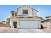 Two-story home featuring a two-car garage, blue door, tile roof, and neutral stucco facade at 4583 Sparwood Dr, Las Vegas, NV 89147