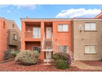 Charming two-story condo building with well-maintained landscaping and visible unit numbers at 4730 E Craig Rd # 1115, Las Vegas, NV 89115