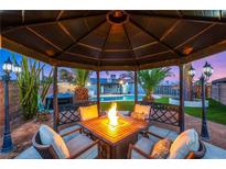 Inviting backyard gazebo featuring a fire pit and comfortable seating, ideal for outdoor entertaining at 4764 Lana Dr, Las Vegas, NV 89121