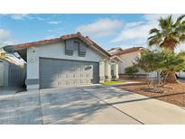 Charming single-story home with a two-car garage and well-maintained landscaping at 5553 Super Bowl Dr, Las Vegas, NV 89110