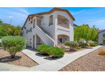 Inviting two-story condo featuring a private balcony, manicured landscaping, and stucco exterior at 5655 E Sahara Ave # 2009, Las Vegas, NV 89142