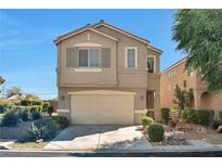 Charming two-story home featuring a two-car garage, complemented by a well-manicured front yard with decorative landscaping at 5740 Winter Cherry St, Las Vegas, NV 89130