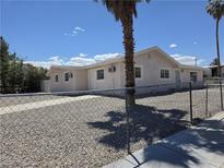 Charming single-story home with stucco siding, a desert landscape, and a chain link fence at 629 N 16Th St, Las Vegas, NV 89101