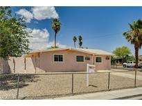 Charming single-story home with desert landscaping, fenced yard, and mature palm trees at 629 N 16Th St, Las Vegas, NV 89101