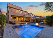 Beautiful backyard with a sparkling pool, spa, fire pit and covered patio for outdoor entertaining at 7322 Columbia Rock Ct, Las Vegas, NV 89178