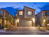 Two-story home with brick driveway and neutral stucco exterior, complete with a two-car garage at 8021 Adelaide Hills St, Las Vegas, NV 89113