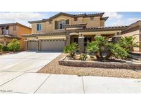 Charming two-story home featuring a three-car garage, stone accents, and a well-manicured front yard at 8547 Benidorm Ave, Las Vegas, NV 89178