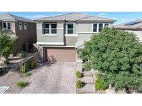 Charming two-story home featuring a well-maintained yard and a brick-paved driveway leading to a two-car garage at 888 Cherry Glen Pl, Las Vegas, NV 89138
