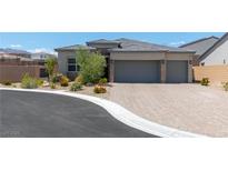 Beautiful single-story home with a two-car garage and a well-manicured front yard at 8929 Cassia Winds St, Las Vegas, NV 89166
