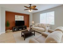 Bright living room features neutral walls, tile floors, and a ceiling fan at 9780 Ziegler Ave, Las Vegas, NV 89148