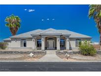 Charming single-story home with beautiful desert landscaping and a well-maintained front yard at 1420 Logandale Dr, Logandale, NV 89021