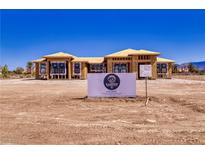 New construction home with a bright blue sky, sign in the front, and wooden framing at 1550 W Jornada St, Pahrump, NV 89048