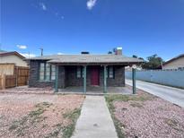 Charming single-story home with stone facade, walkway, and desert landscaping under a blue sky at 1844 Yale St, North Las Vegas, NV 89030