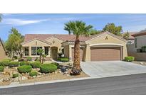 Charming single-story home featuring a well-manicured yard, desert landscaping, and a two-car garage at 2110 Fort Sanders St, Henderson, NV 89052