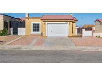 Charming single-story home with a red tile roof, desert landscaping, and an attached single-car garage at 2337 Sierra Sunrise St, Las Vegas, NV 89156