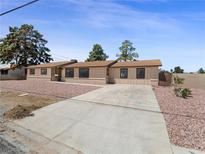 Charming single-story home featuring a long driveway and well-maintained front yard landscape at 2375 Marion St, Las Vegas, NV 89104