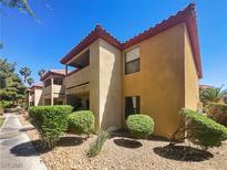 Two-story tan apartment building with red-tile roofing and well-maintained landscaping at 3135 S Mojave Rd # 152, Las Vegas, NV 89121