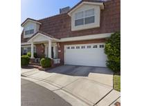 Charming two-story home boasts a well-manicured yard and an attached two-car garage at 3233 Southridge Ave, Las Vegas, NV 89121