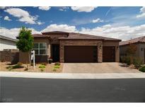 Charming single-story home featuring a brick-accented facade, desert landscaping, and a spacious two-car garage at 3395 Sleeping Hills Ave, Henderson, NV 89044