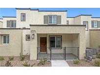 Charming townhome featuring a covered porch and modern architectural design, set against a clear blue sky at 3517 Arcadian King Ave, Las Vegas, NV 89106