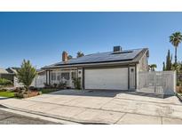 Charming single-story home with a well-maintained yard, solar panels, and a two-car garage at 4302 Newhaven Dr, Las Vegas, NV 89147
