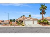 Charming single-story home with a three-car garage, desert landscaping, and a beautiful palm tree at 5421 Tourmaline St, Las Vegas, NV 89130