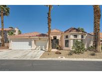 Charming single-story home featuring a three-car garage and desert landscaping at 5638 Wild Olive St, Las Vegas, NV 89118