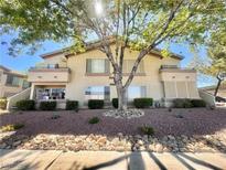 Inviting two-story condo with a well-maintained facade and mature shade trees at 5710 E Tropicana Ave # 1055, Las Vegas, NV 89122