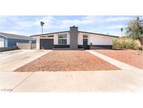 Charming single-story home with a unique exterior paint, rock landscaping, and a well-maintained front yard at 6205 Hargrove Ave, Las Vegas, NV 89107