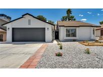 Charming single-story home with a well-maintained, low-water landscaped front yard and two-car garage at 6939 Paddington Way, Las Vegas, NV 89147