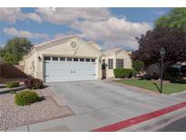 Charming single-story home featuring a two-car garage and well-maintained landscaping at 7697 Morning Lake Dr, Las Vegas, NV 89131