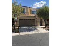 Inviting two-story home featuring a neutral color scheme, attached two-car garage, and well-maintained landscaping at 7929 Valladolid Ave, Las Vegas, NV 89178