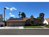 Charming single-story home featuring a two-car garage, tile roof, solar panels and well-manicured lawn at 8316 Vibrant Dr, Las Vegas, NV 89117