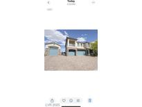 Stunning two-story home featuring a three-car garage, balcony and lush landscaping at 8528 Baltimore Heights Ct, Las Vegas, NV 89113