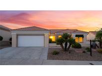 Inviting single-story home with a two-car garage and well-maintained desert landscaping at 9812 Folsom Dr, Las Vegas, NV 89134