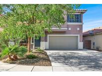 Charming two-story home features a well-manicured lawn and attached two car garage at 10046 Floragold Ct, Las Vegas, NV 89147